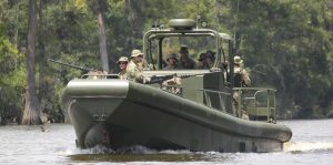 Silver Ships riverine patrol boat with soldiers and weapon mounts