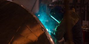 Silver Ships worker welds an aluminum boat