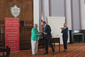 Steven Clarke, CEO of Silver Ships, accepts award from Alabama governor Kay Ivey