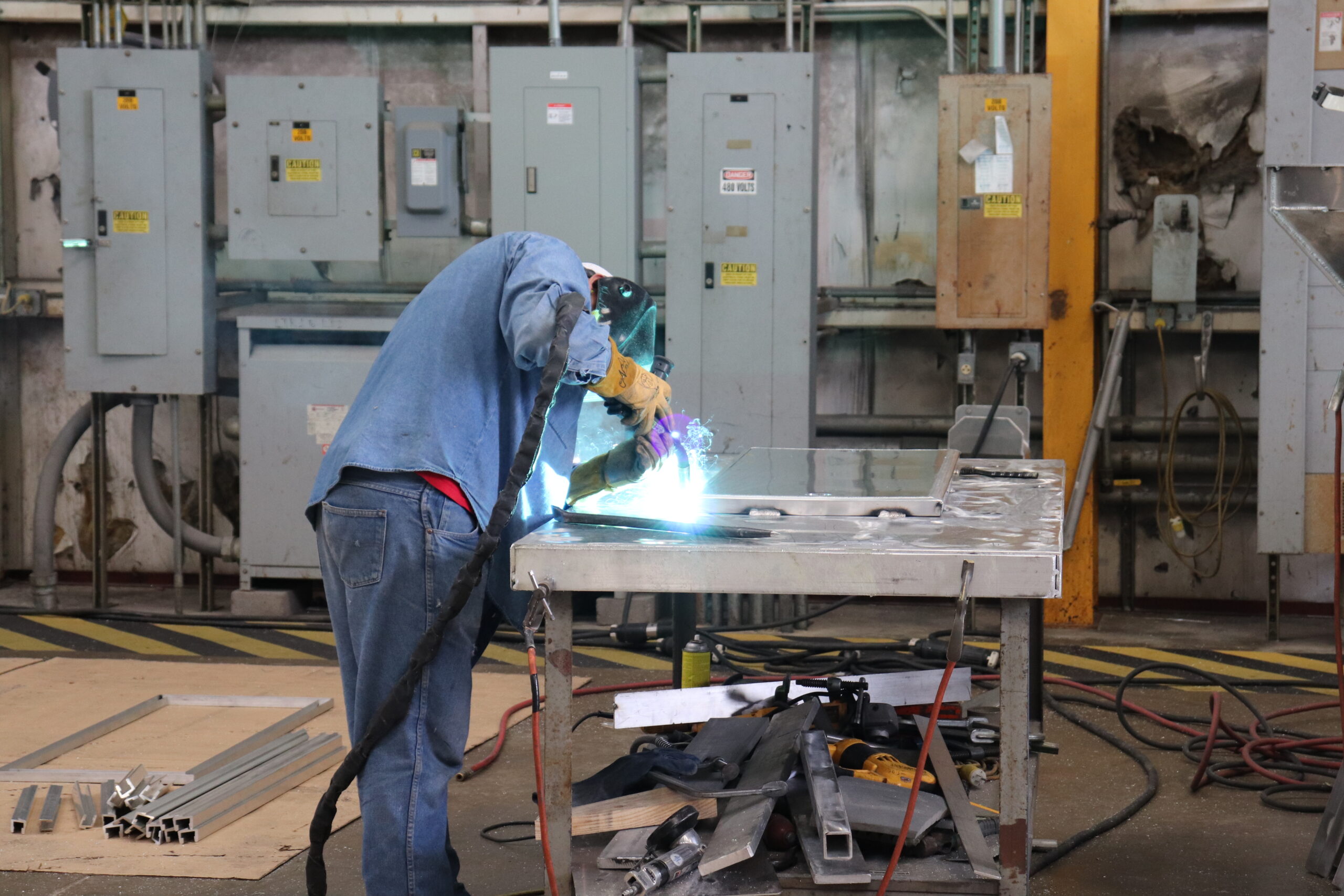Ship builder in shop building aluminum workboat